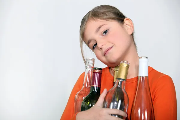 Girl with empty glass bottles — Stock Photo, Image