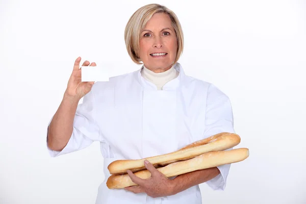 Mulher segurando pão e mostrando seu cartão pessoal — Fotografia de Stock