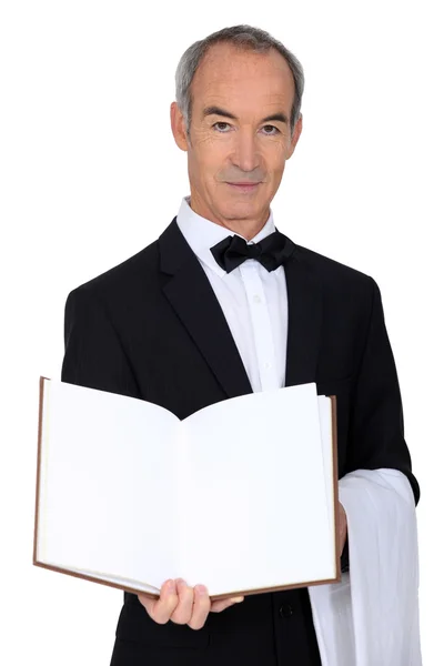Grey haired waiter with menu — Stock Photo, Image