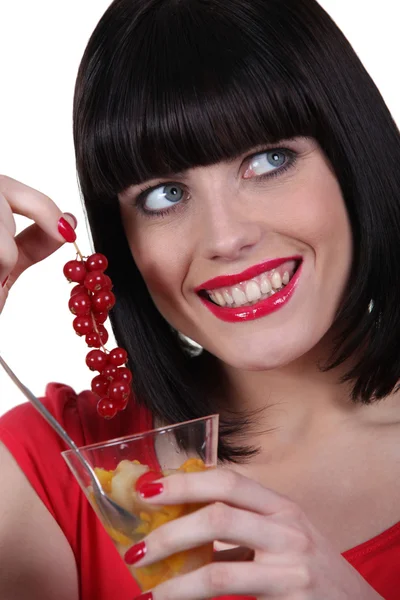 Woman eating fruit salad Stock Picture