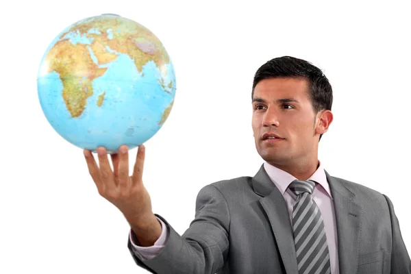 Ambitieuze zakenman met globe in hand Stockfoto