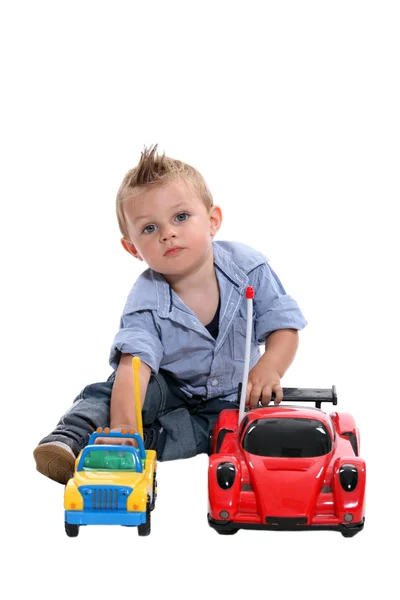 Tot with gelled hair playing with toy cars — Stock Photo, Image