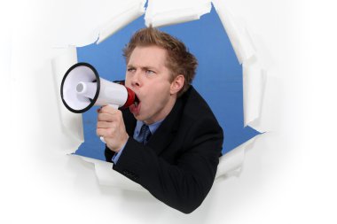 Businessman yelling into a blowhorn clipart