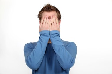 Man covering his face in shame clipart