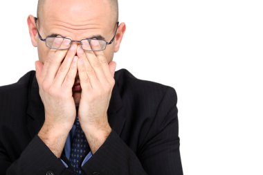 Tired businessman rubbing his eyes clipart