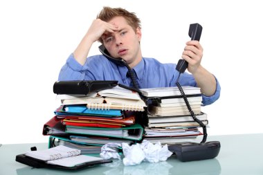 An overwhelmed businessman. clipart