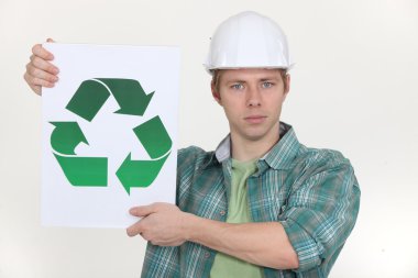 Builder holding the universal recycling symbol clipart