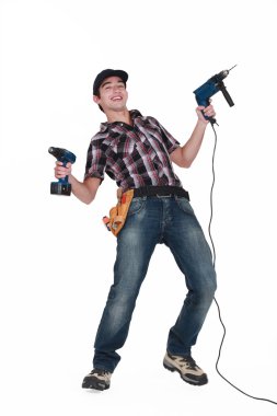 A tradesman holding power tools clipart