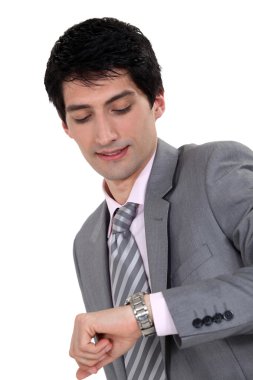 Businessman looking at the time clipart