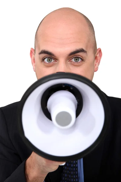 Homem de negócios careca falando através de megafone — Fotografia de Stock