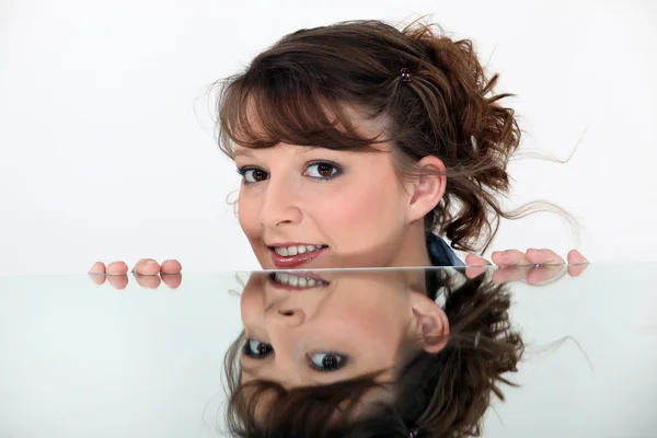 Face of woman reflected in mirror — Stock Photo, Image