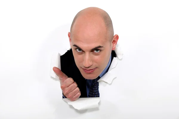 Bald man bursting through poster giving thumbs-up — Stock Photo, Image