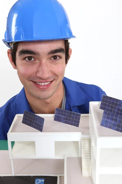 Portrait of young bricklayer posing near model — Stock Photo, Image