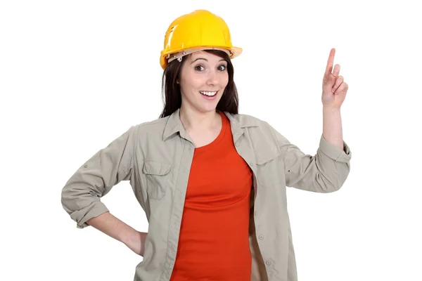 Female construction worker holding up her finger — Stock Photo, Image