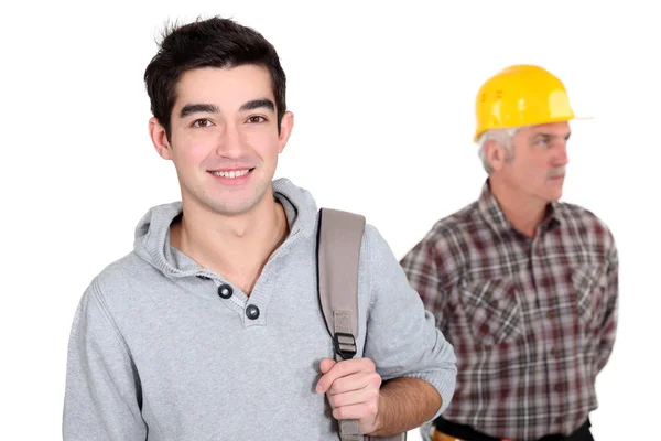 Young apprentice posing next to a senior craftsman — Stock Photo, Image