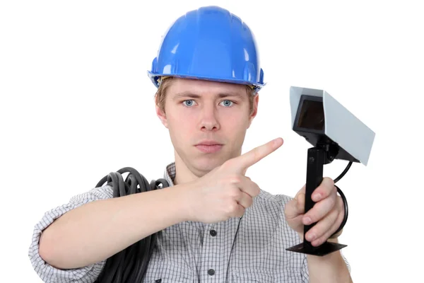 Technician pointing to CCTV camera — Stock Photo, Image