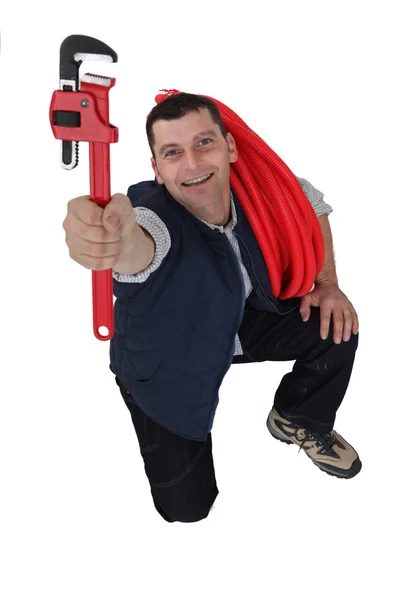 Tradesman segurando uma chave de tubo — Fotografia de Stock