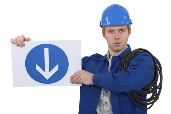 Electrician holding road sign — Stock Photo, Image