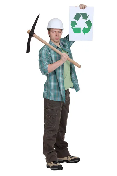 Man with pick-axe holding recycle logo — Stock Photo, Image