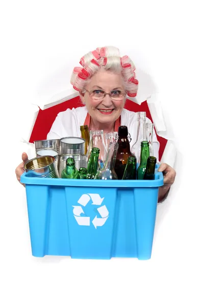 Stock image Old woman recycling bottles and cans