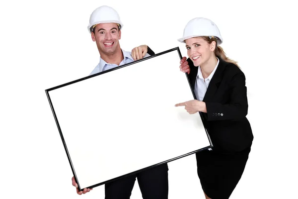 Cheerful architects with a blank board — Stock Photo, Image