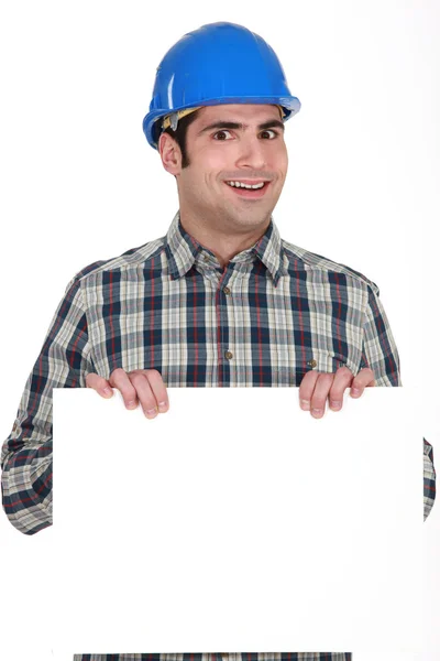 Builder with a board left blank for your message — Stock Photo, Image