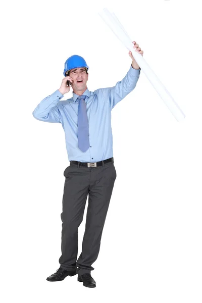 Young architect shouting down mobile telephone — Stock Photo, Image
