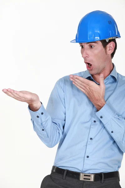 Engineer looking at his hand in amazement — Stock Photo, Image