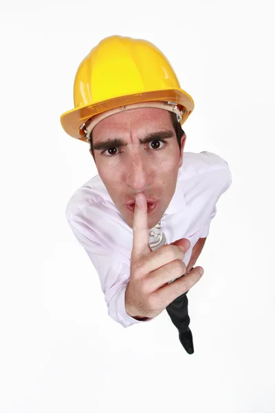 Foreman asking for silence with finger on the mouth — Stock Photo, Image