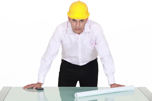 Architect with determined gaze and arms resting on glass table — Stock Photo, Image