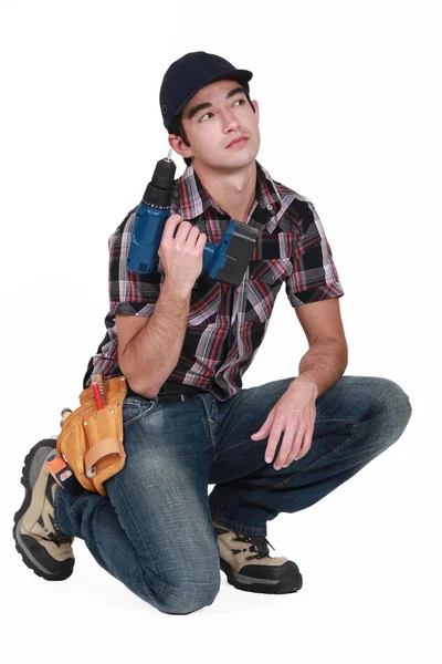 Pensive builder holding drill — Stock Photo, Image