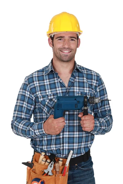 Construtor com uma broca elétrica — Fotografia de Stock