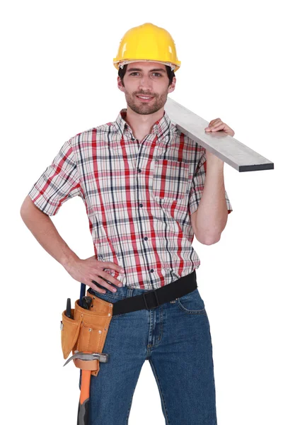 Craftsman with wood plank over his shoulder — Stock Photo, Image
