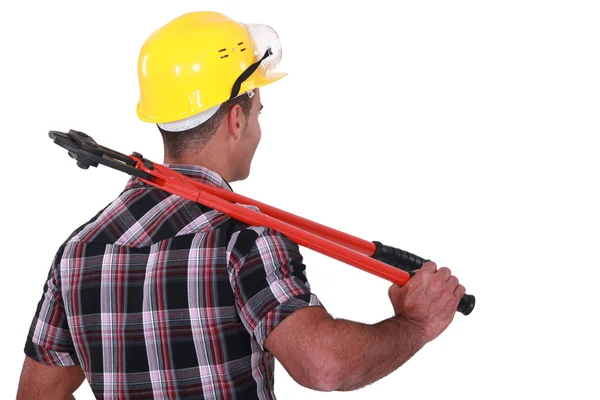 Tradesman carrying a pair of large clippers on his shoulder — Stock Photo, Image