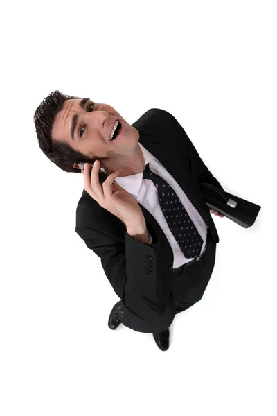 Businessman talking on the phone and laughing — Stock Photo, Image
