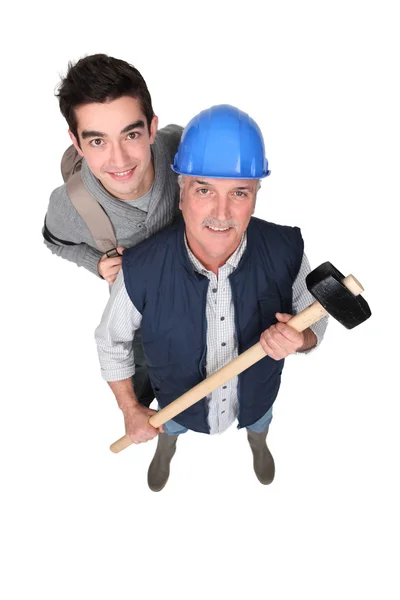 A manual worker and his grandson. Royalty Free Stock Photos