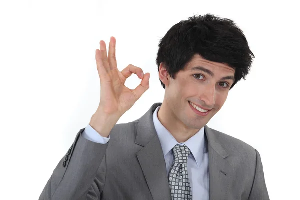 Businessman making an OK sign Stock Picture