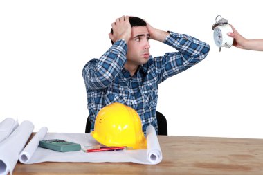 Stressed worker looking at a clock clipart