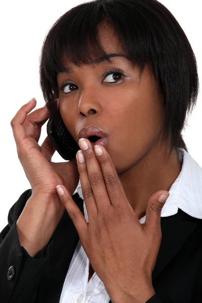 Afro zakenvrouw verrast aan de telefoon — Stockfoto