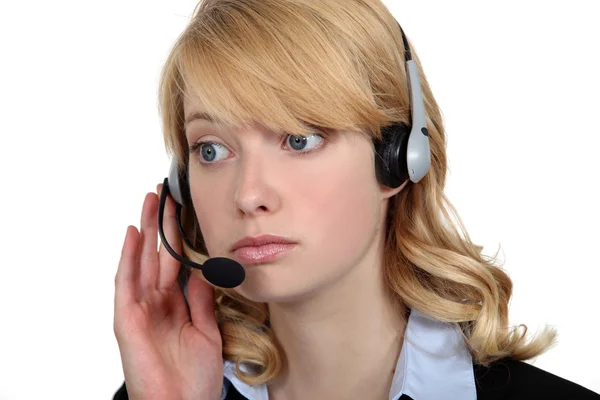 Blond call-center worker listening to customer — Stock Photo, Image