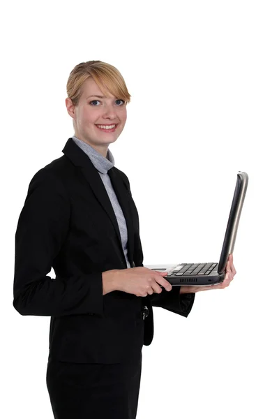 Businesswoman standing with a laptop — Stock Photo, Image