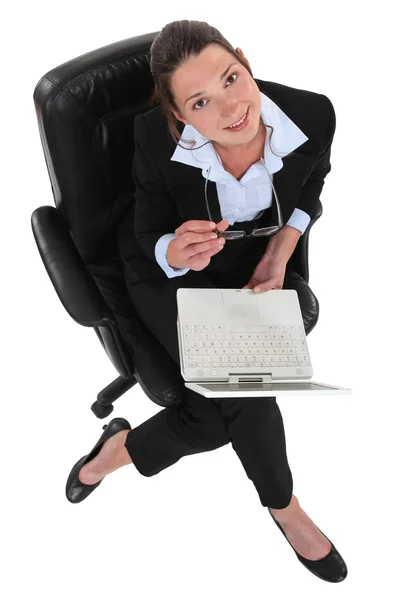 Businesswoman sat in office chair with laptop — Stock Photo, Image