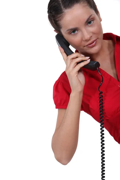 stock image Young brunette over the phone.