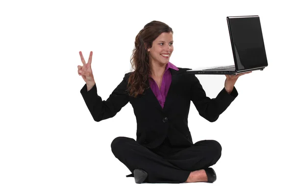 Geschäftsfrau saß auf dem Boden und machte Friedenszeichen — Stockfoto