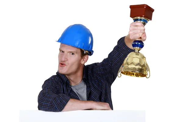 Builder holding trophy — Stock Photo, Image