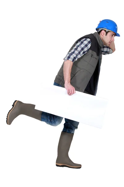 Speedy tradesman holding a blank sign — Stock Photo, Image