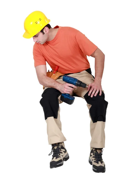 Handyman casually sat with drill — Stock Photo, Image
