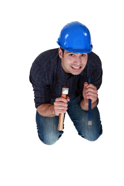Nervous woodworker holding hammer and chisel — Stock Photo, Image
