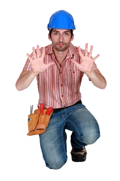 Tradesman holding up his hands — Stock Photo, Image