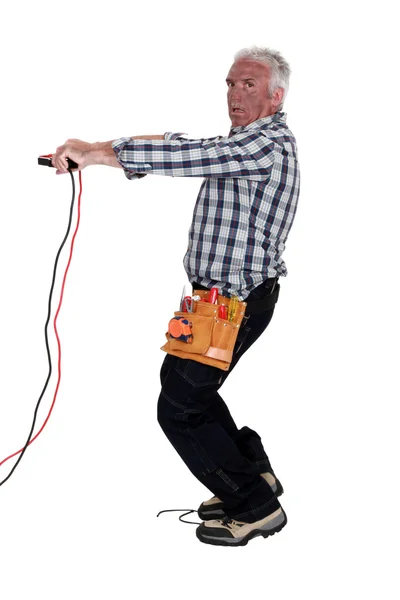 Electrocuted man holding jumper cables — Stock Photo, Image
